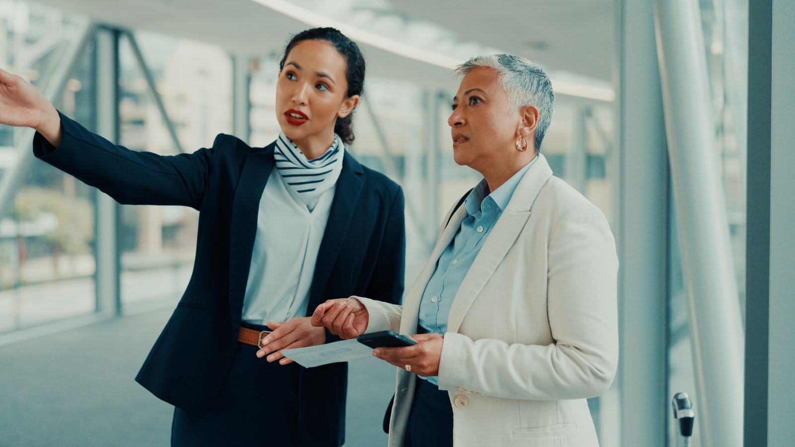 Staff member assisting a traveler inside a modern terminal